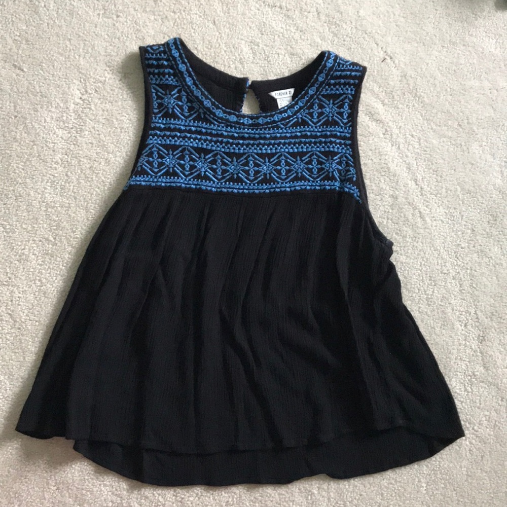 black top with blue embroidery